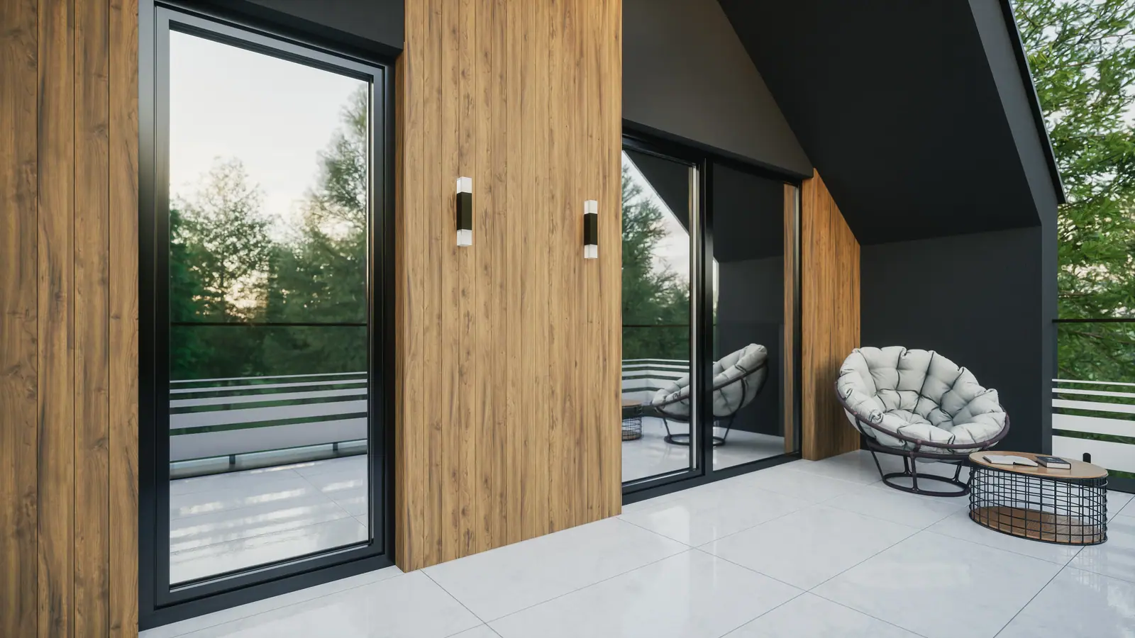Raumhohe Fenster und Schiebetür in Anthrazit mit Aluminium-Aufsatz an einer Holzfassade, davor eine überdachte Terrasse